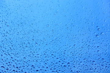 Water drops on glass, natural blue texture