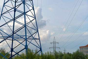 A blue electric pole transmits energy. High voltage line with wires. Electricity transmission, volt.