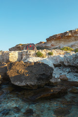The tent stands on a sea of stone. View from the water