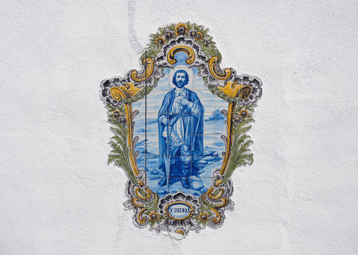Saint Isidore, decorative ceramic tiles with blue and golden colors in Portugal