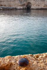 Musical instrument glucophone on a rocky seashore