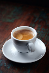 Cup of coffee on rustic wooden background. Copy space.