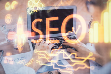 Double exposure of seo icon with man working on computer on background. Concept of search engine...