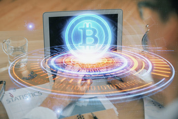 Blockchain theme hologram with man working on computer on background. Concept of crypto chain....