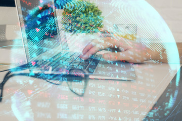 Double exposure of businessman working on laptop on background. International business hologram in...