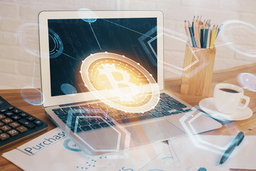 Double exposure of blockchain and crypto economy theme hologram and table with computer background. Concept of bitcoin cryptocurrency.