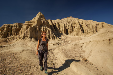 Fototapeta na wymiar A hiker in the Artist`s Palette landmark place in Death Valley National Park, Geology, sand.