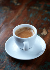 Cup of coffee on rustic wooden background. Copy space.