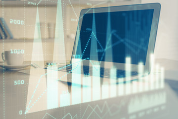 Forex graph hologram on table with computer background. Multi exposure. Concept of financial markets.