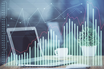 Naklejka premium Financial graph colorful drawing and table with computer on background. Double exposure. Concept of international markets.