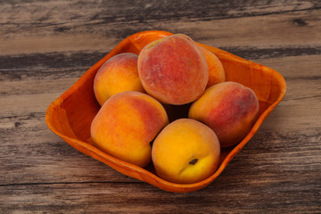 Peach heap in the wooden basket