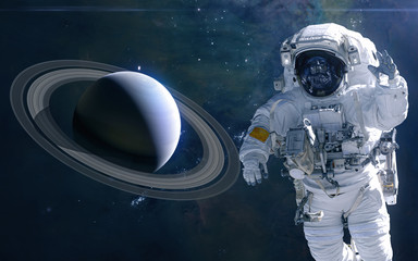 Saturn and astronaut. Solar system. Science fiction. Elements of this image furnished by NASA