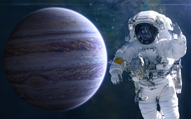 Jupiter and astronaut. Solar system. Science fiction. Elements of this image furnished by NASA