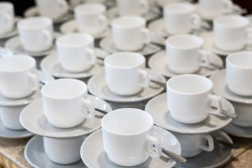 Serving white porcelain coffee and tea cups with saucer