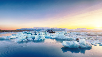 Beautifull landscape with floating icebergs in Jokulsarlon glacier lagoon at sunset