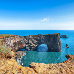 Gorgeous landscape with unique basalt arch on Dyrholaey Nature Reserve on Atlantic South Coast