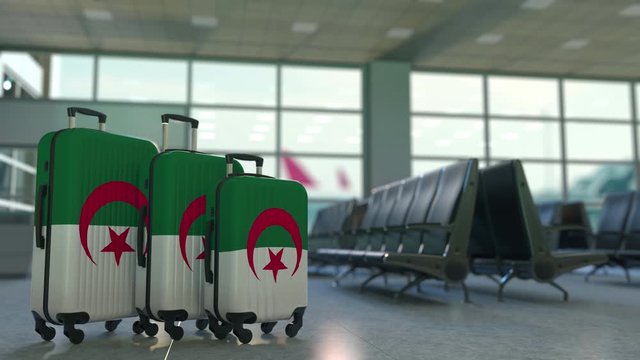 Travel suitcases with flag of Algeria. Algerian tourism conceptual 3D animation