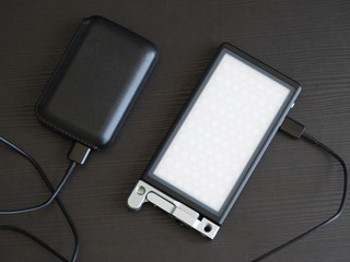The portable compact RGB light source is charged by portable charging.