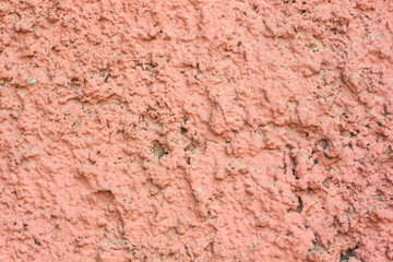 Vintage pink background. Texture of cement plaster. Rough painted wall of fiesta color. Copy space.