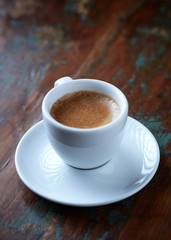 Cup of coffee on rustic wooden background. Copy space.