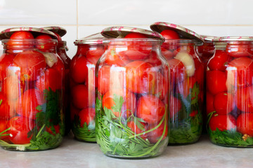Pickling tomatoes in glass jars