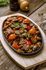 Roast beef and vegetables on wooden background. Turkish cuisine