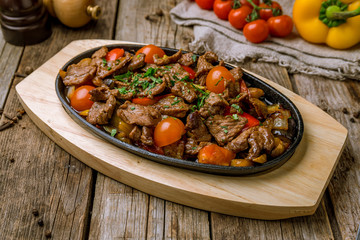Roast beef and vegetables on wooden background. Turkish cuisine