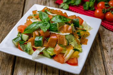 Vegetable salad with tomatoes and cucumbers and fried chips. Turkish cuisine