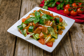 Vegetable salad with tomatoes and cucumbers and fried chips. Turkish cuisine