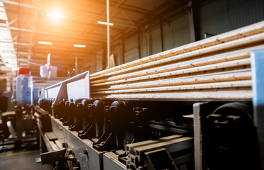 Production line of the wooden floor factory. CNC automatic woodworking machine.