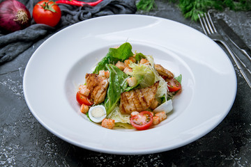 Salad caesar with chicken on grey concrete background