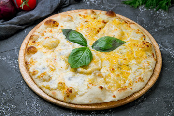 Pizza Quattro formaggi on grey concrete background