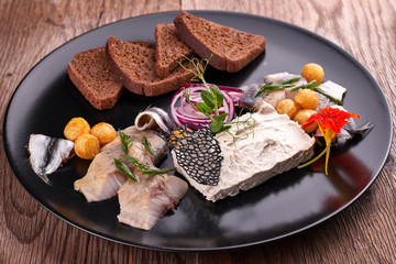 Forshmak on a black plate