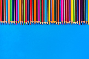 Colored pencils on a blue background