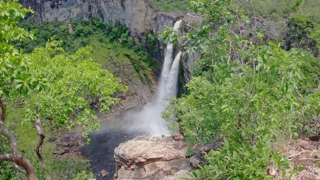 High waterfall in green canyon forest with rainbow - Zoom Out