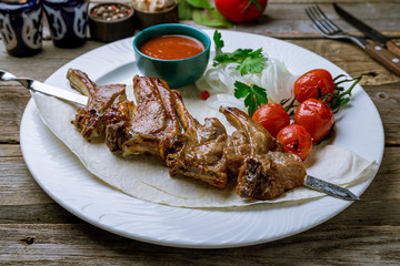 kebab from a rack of lamb on old wooden table