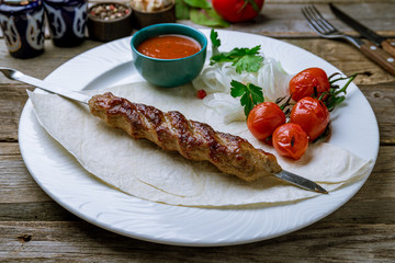 Lamb Lula kebab on old wooden table