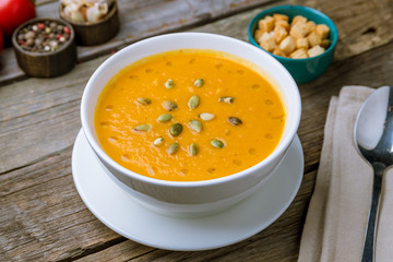 Soup cream of pumpkin on old wooden table