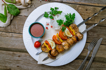 grilled vegetables and mushrooms on a plate on old wooden table
