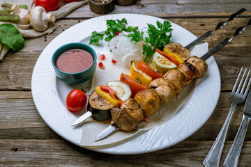 grilled vegetables and mushrooms on a plate on old wooden table