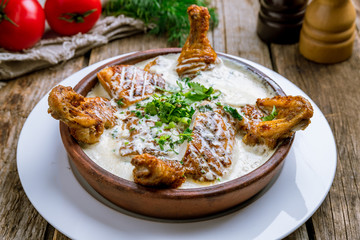 chicken chkmeruli in Georgian on wooden table