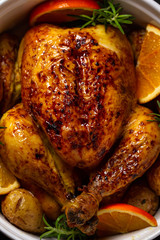 Roasted chicken with oranges ,rosemary and potato. Top view