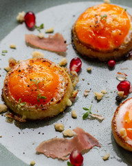 Fried eggs in onion rings on plate. Eggs for breakfast.