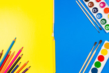 Set of school and preschool baby supplies. Pencil and watercolor paint on the table. Color block.