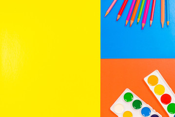Set of school and preschool baby supplies. Pencil and watercolor paint on the table. Color block.