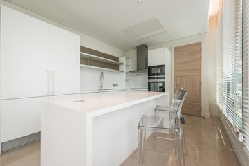Stylish kitchen interior with dining table and chairs