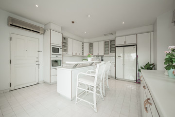 Stylish kitchen interior with dining table and chairs