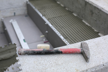 Tiler hands working on a new house entrance, local and professional handyman applying tiles to the steps.