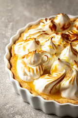 Lemon tart with meringue on table. Sweet lemon dessert.