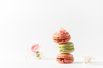 Different types of macaroons on a white background. Pink and green macaroons.